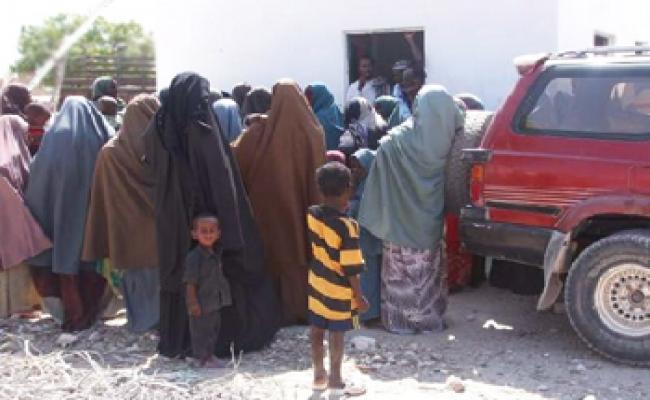 mothers line up with their enrolled children in PlumpyNut distribution