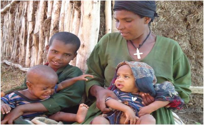 Assefash Metese and her family at a distribution site in Ebinat, Amhara Region