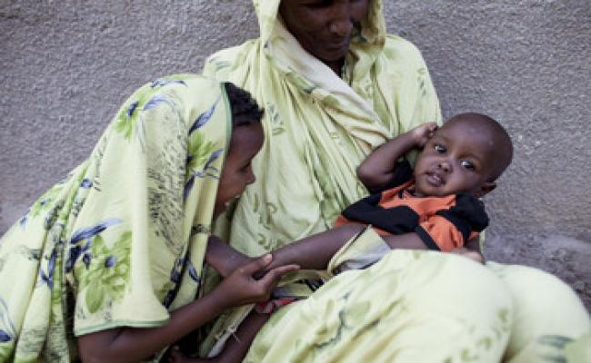 Bishara at 18 months old, looking much healthier and playing with her grandmother