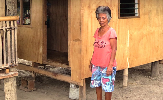 Editha has been supported with cash for work to help her restore her home.