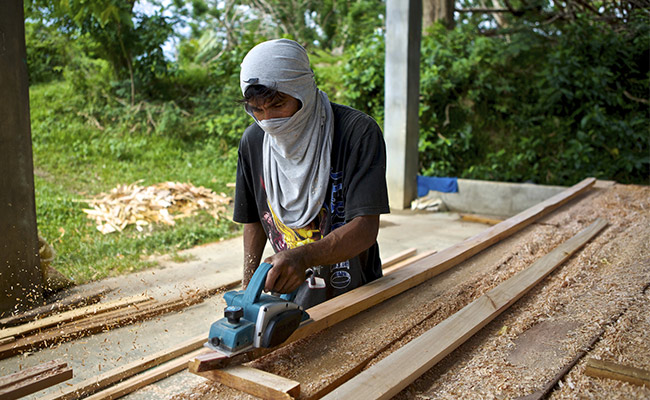 A local fisherman from Concepcion works to build a boat in Concern's boat yard.