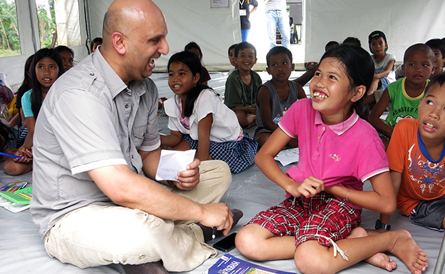 Saleh Saeed with Cherrie Mae at World Vision run child friendly space