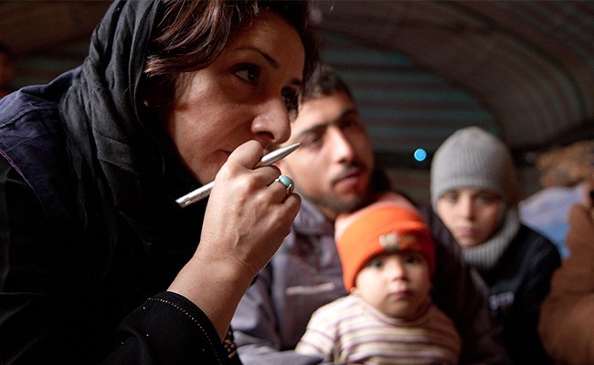 Samina Haq, Islamic Relief, talking with displaced Syrian people