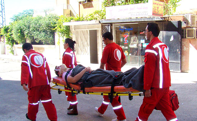 SARC (partner of DEC member British Red Cross) volunteers carrying stretcher in Homs