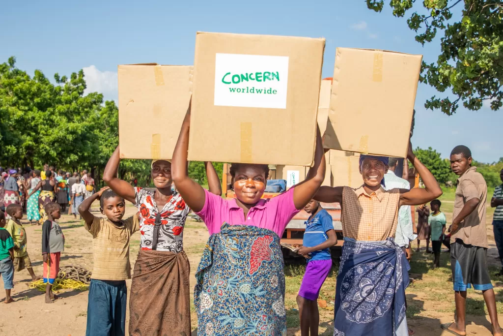 Women carry boxes of aid