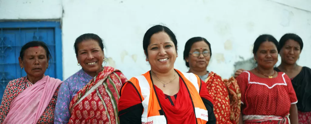 An aid worker stands with women she is helping