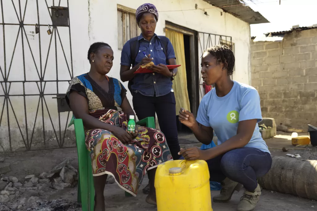 An aid worker demonstrates handwashing